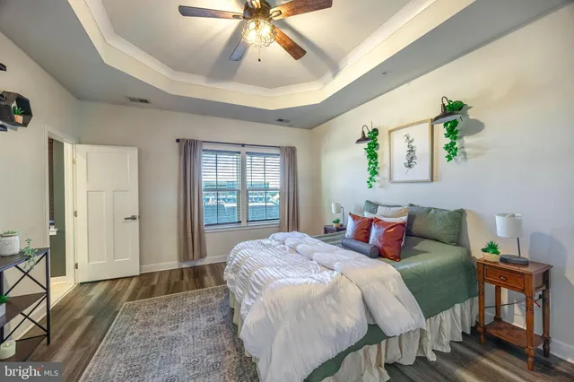 a large bed sitting in a bedroom next to a window