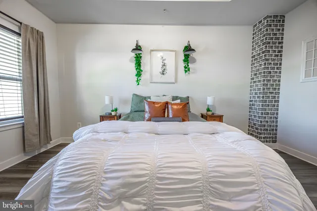 a bedroom with a bed and window