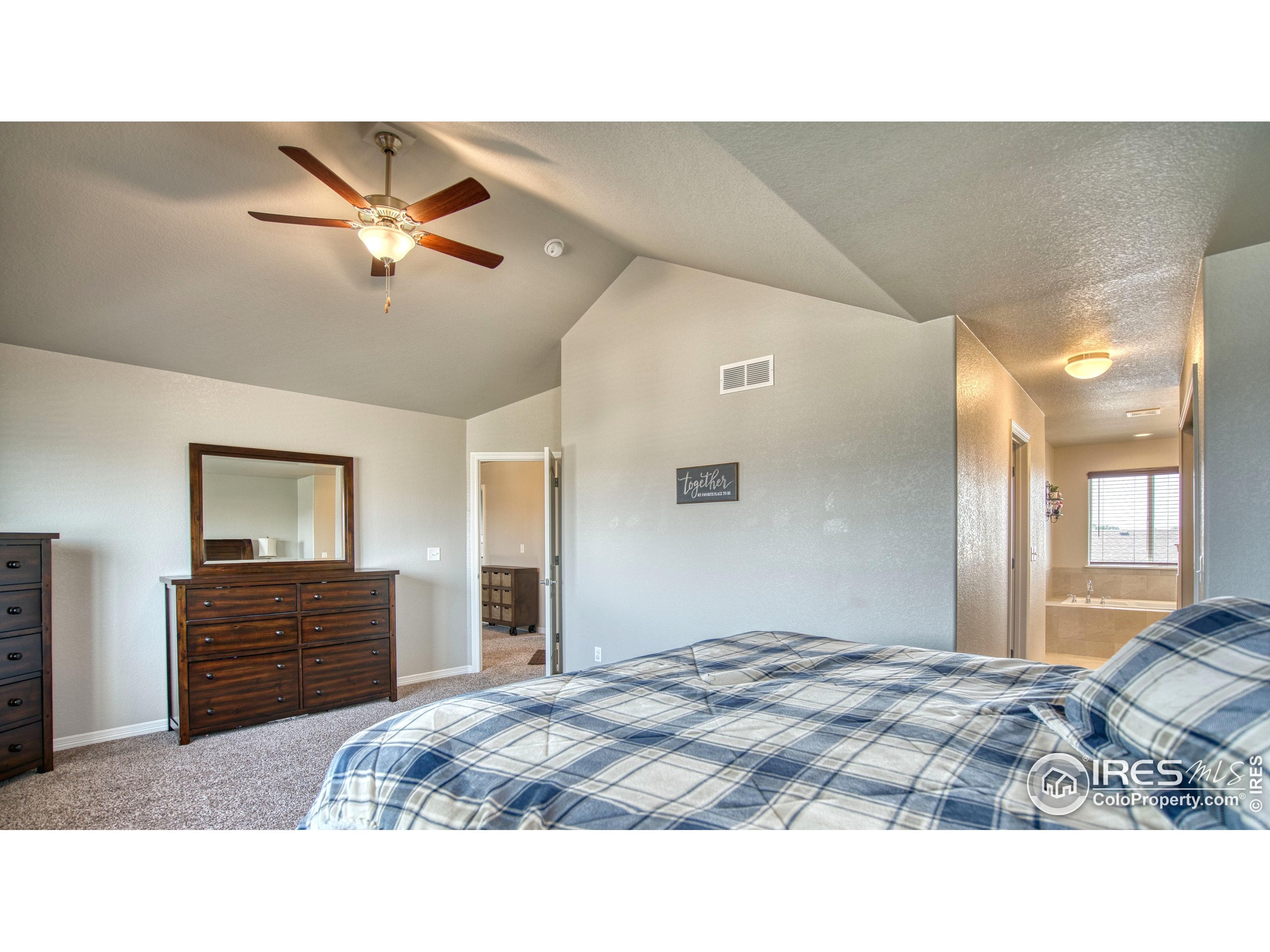1866 Egnar Street Loveland, CO 80538 - Photo 15 of 28 a bedroom with a bed and a chandelier