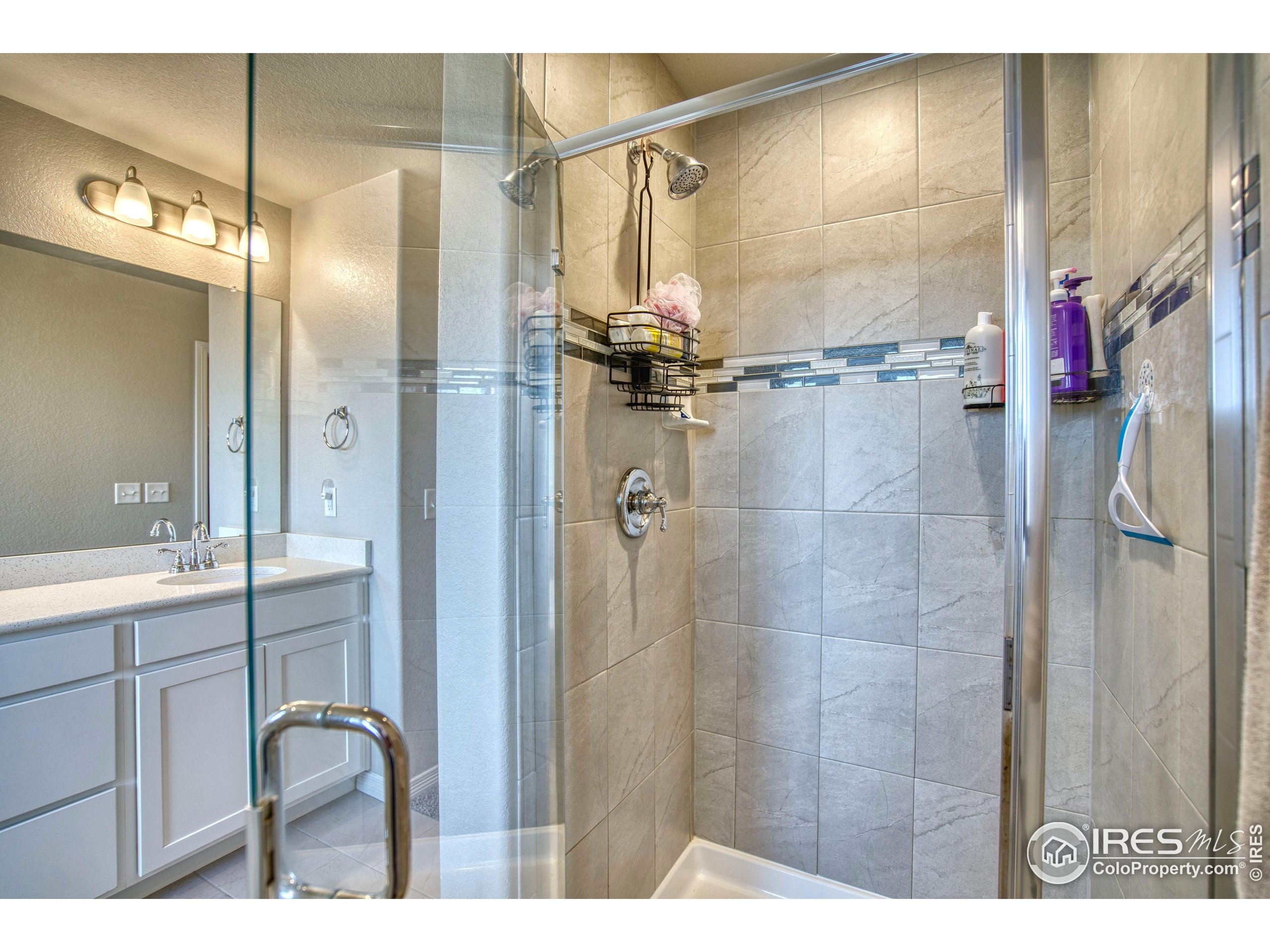 1866 Egnar Street Loveland, CO 80538 - Photo 17 of 28 a bathroom with a glass shower door