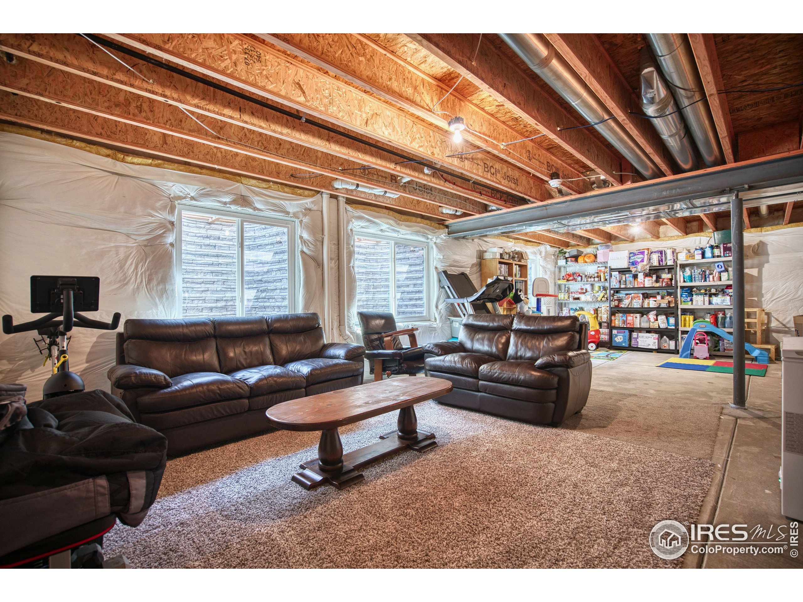 1866 Egnar Street Loveland, CO 80538 - Photo 23 of 28 a living room with furniture and a flat screen tv