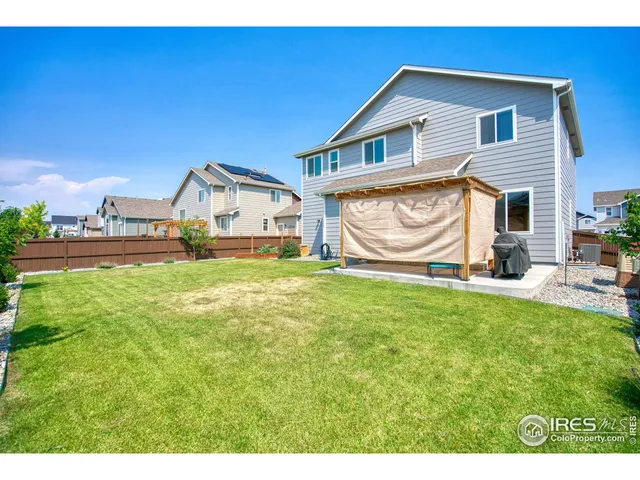 an aerial view of a city with lots of residential buildings ocean and mountain view in back