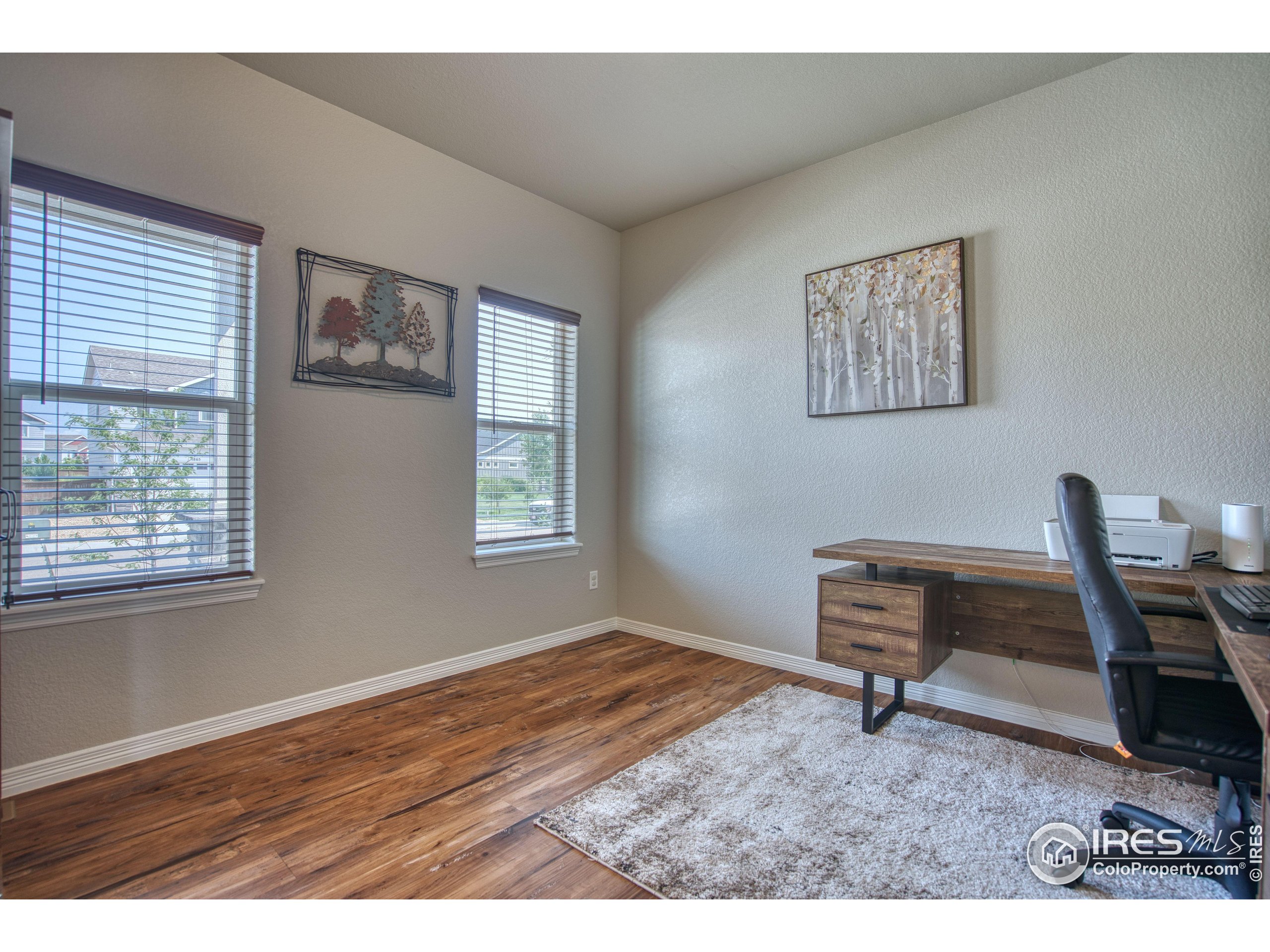 1866 Egnar Street Loveland, CO 80538 - Photo 9 of 28 a workspace room with wooden floor furniture and a window