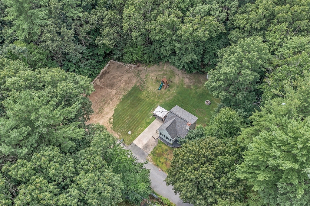 58 Indian Road Groton, MA 01450 - Photo 1 of 35 an aerial view of a house with a yard and lake view