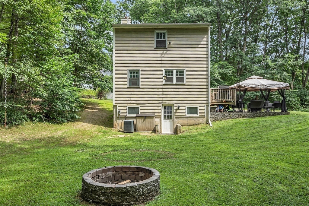 58 Indian Road Groton, MA 01450 - Photo 13 of 35 a backyard of a house with table and chairs