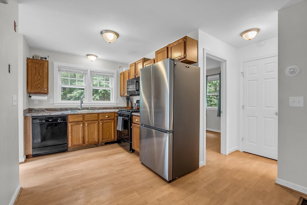 58 Indian Road Groton, MA 01450 - Photo 18 of 35 a kitchen with stainless steel appliances granite countertop a refrigerator and a stove