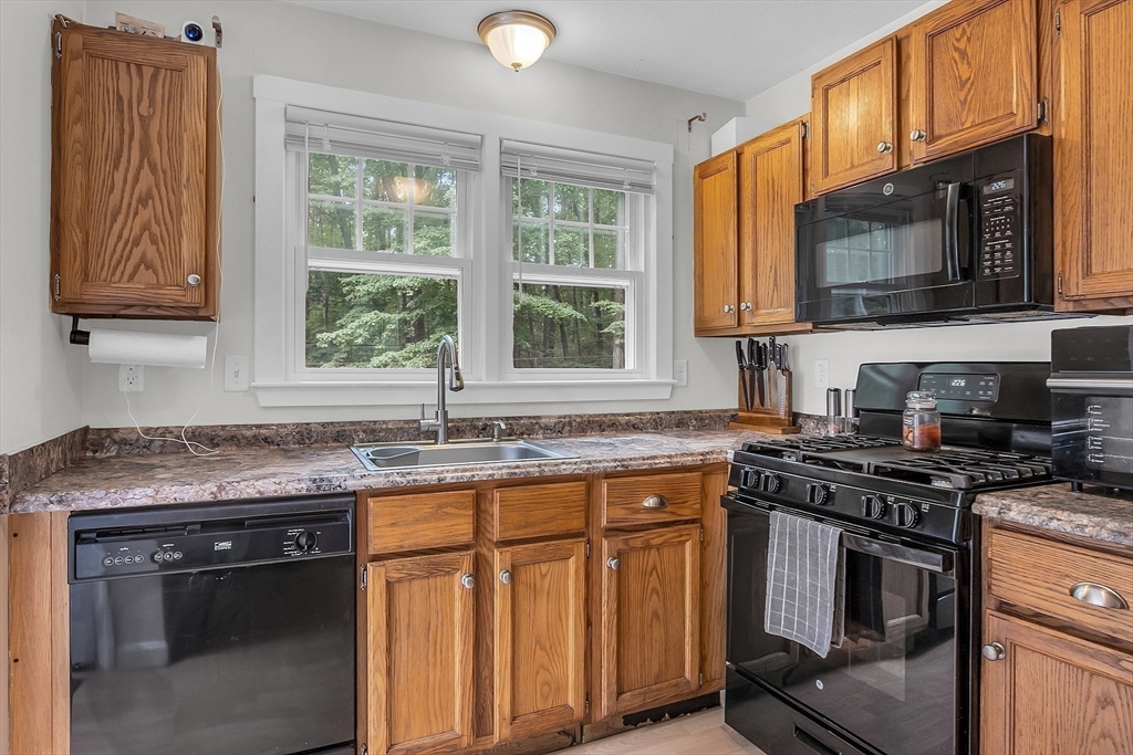 58 Indian Road Groton, MA 01450 - Photo 19 of 35 a kitchen with granite countertop a stove sink and microwave