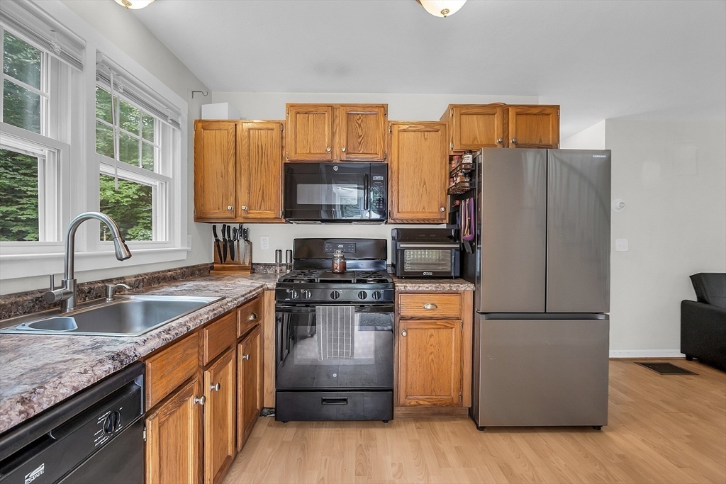 58 Indian Road Groton, MA 01450 - Photo 20 of 35 a kitchen with stainless steel appliances granite countertop a refrigerator stove and sink