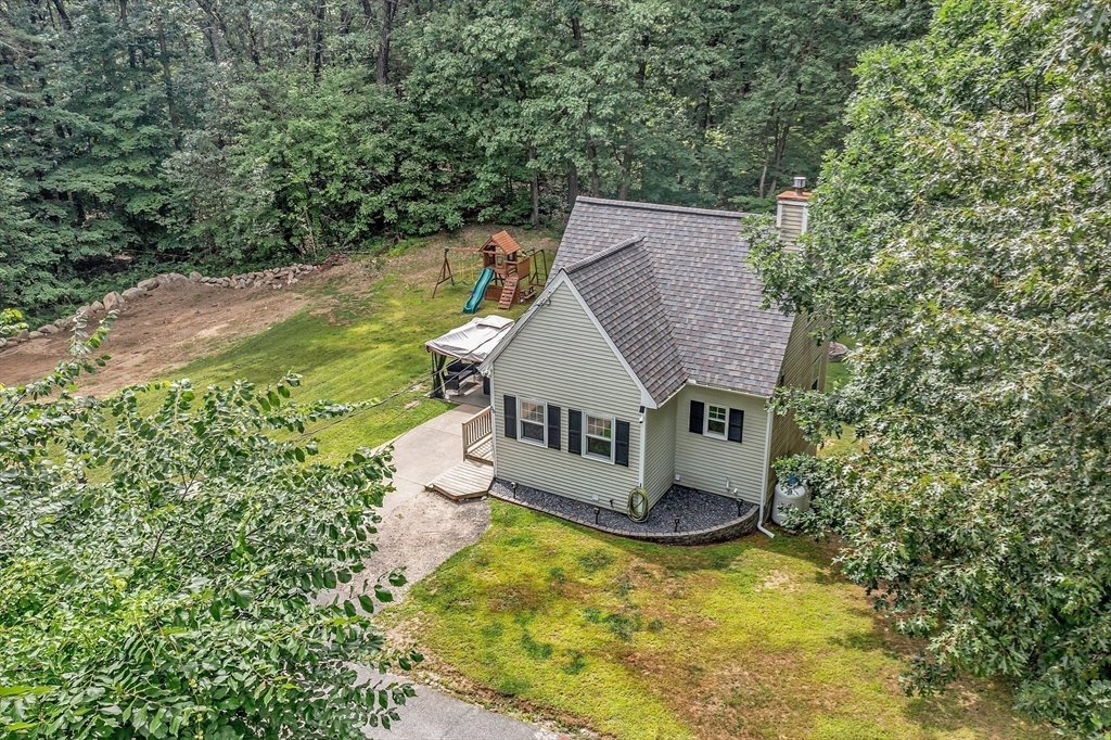58 Indian Road Groton, MA 01450 - Photo 3 of 35 an aerial view of a house with a yard table and chairs