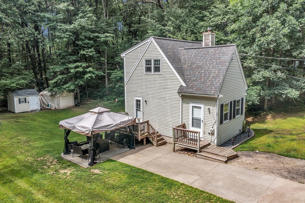 58 Indian Road Groton, MA 01450 - Photo 6 of 35 a view of a house with a yard chairs and a table
