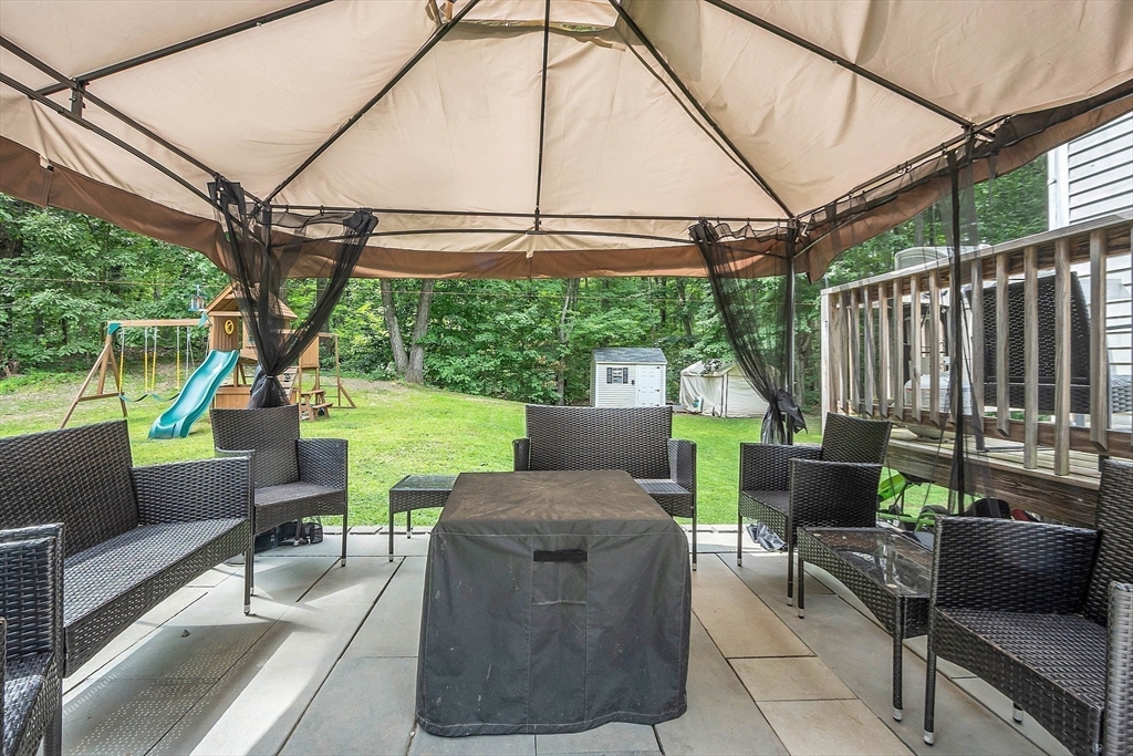 58 Indian Road Groton, MA 01450 - Photo 8 of 35 a view of a patio with couches chairs potted plants and a small yard