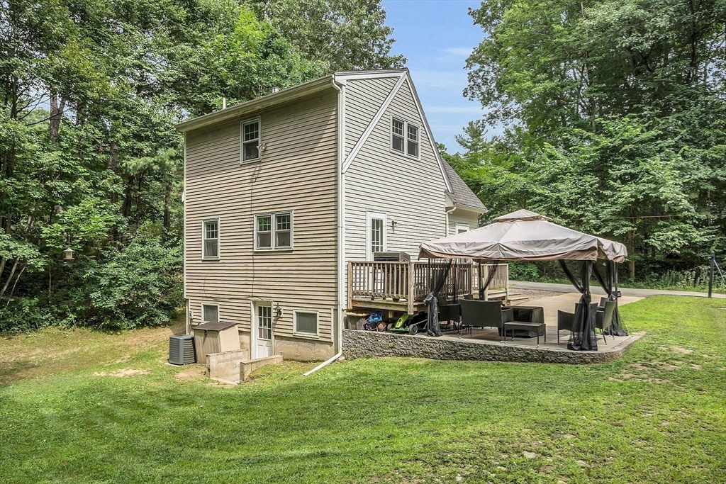 58 Indian Road Groton, MA 01450 - Photo 10 of 35 a view of a house with a yard porch and sitting area