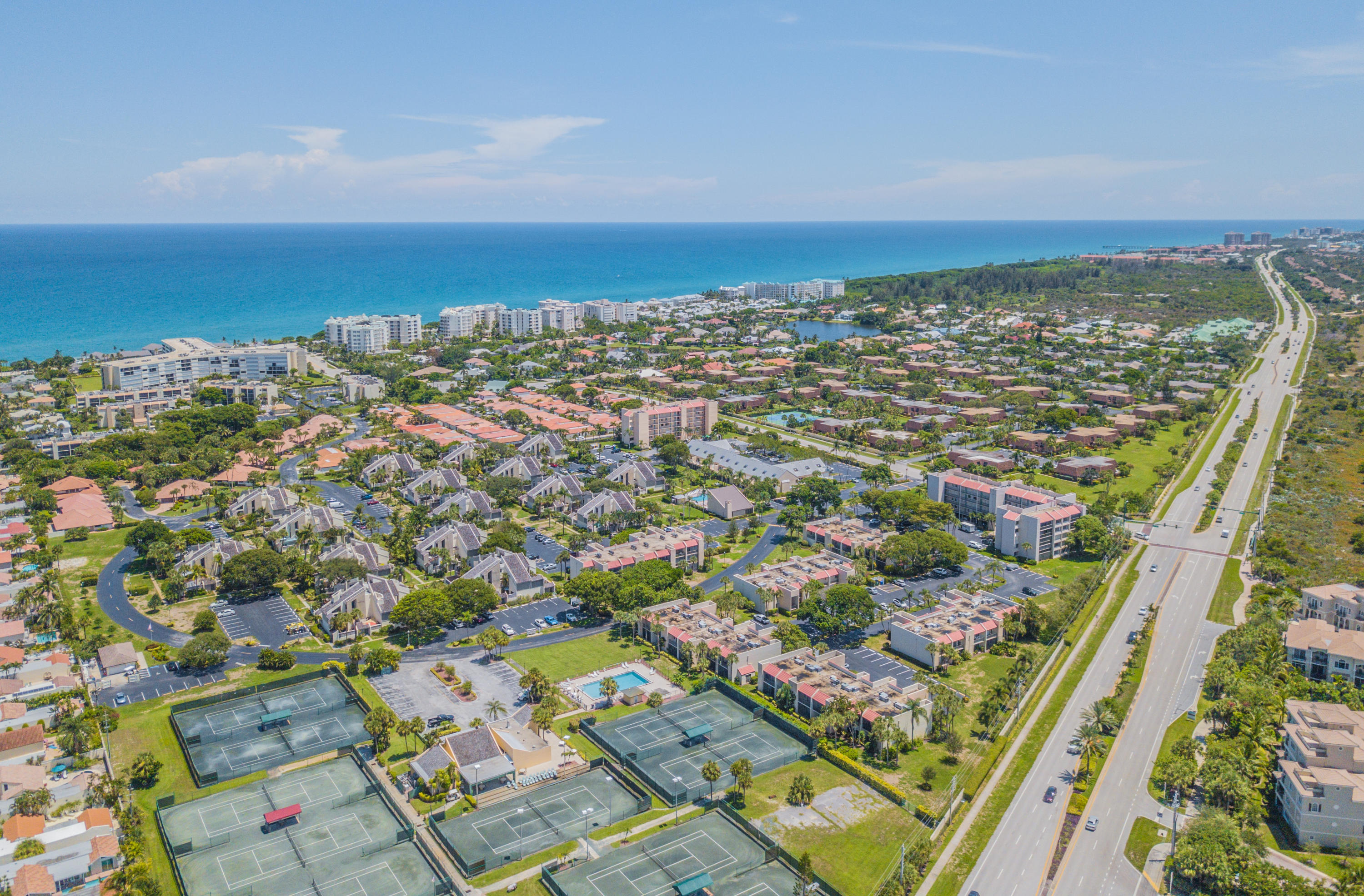 an aerial view of residential building and ocean