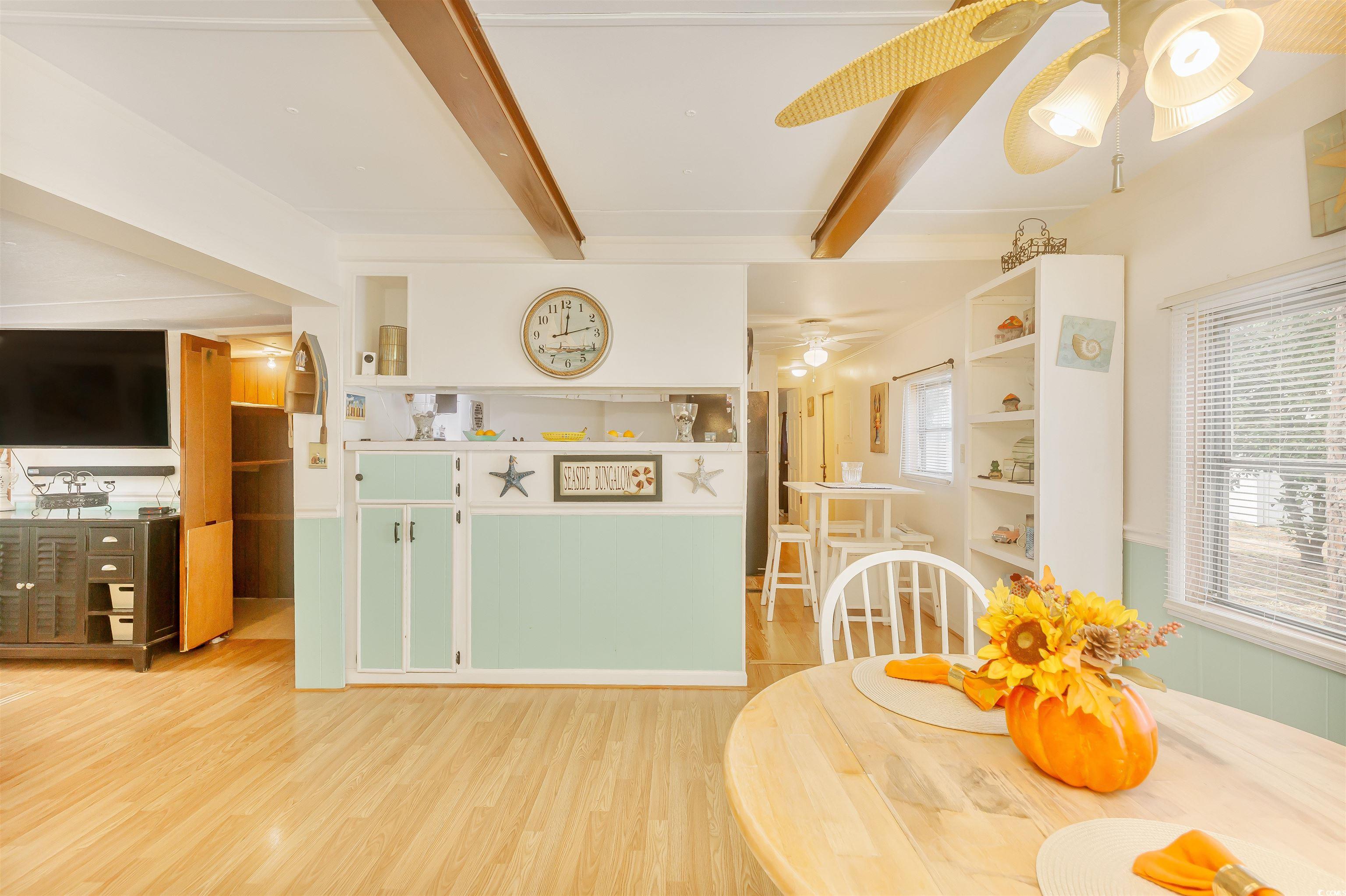 382 West Canal Street Murrells Inlet, SC 29576 - Photo 15 of 38 Dining space with ceiling fan, wood-type flooring, and beam ceiling