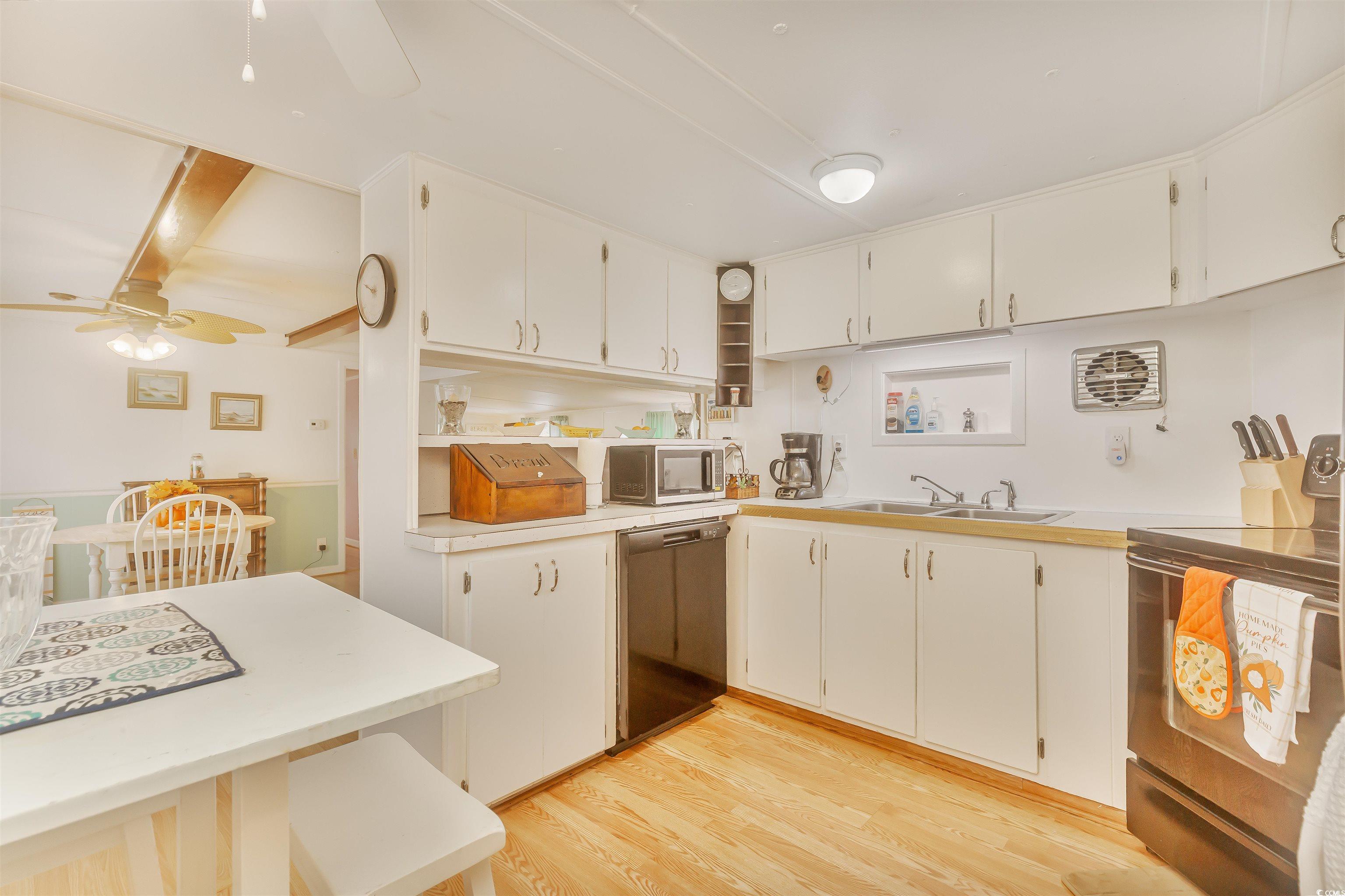 382 West Canal Street Murrells Inlet, SC 29576 - Photo 19 of 38 Kitchen with white cabinetry, dishwasher, sink, and range with electric cooktop