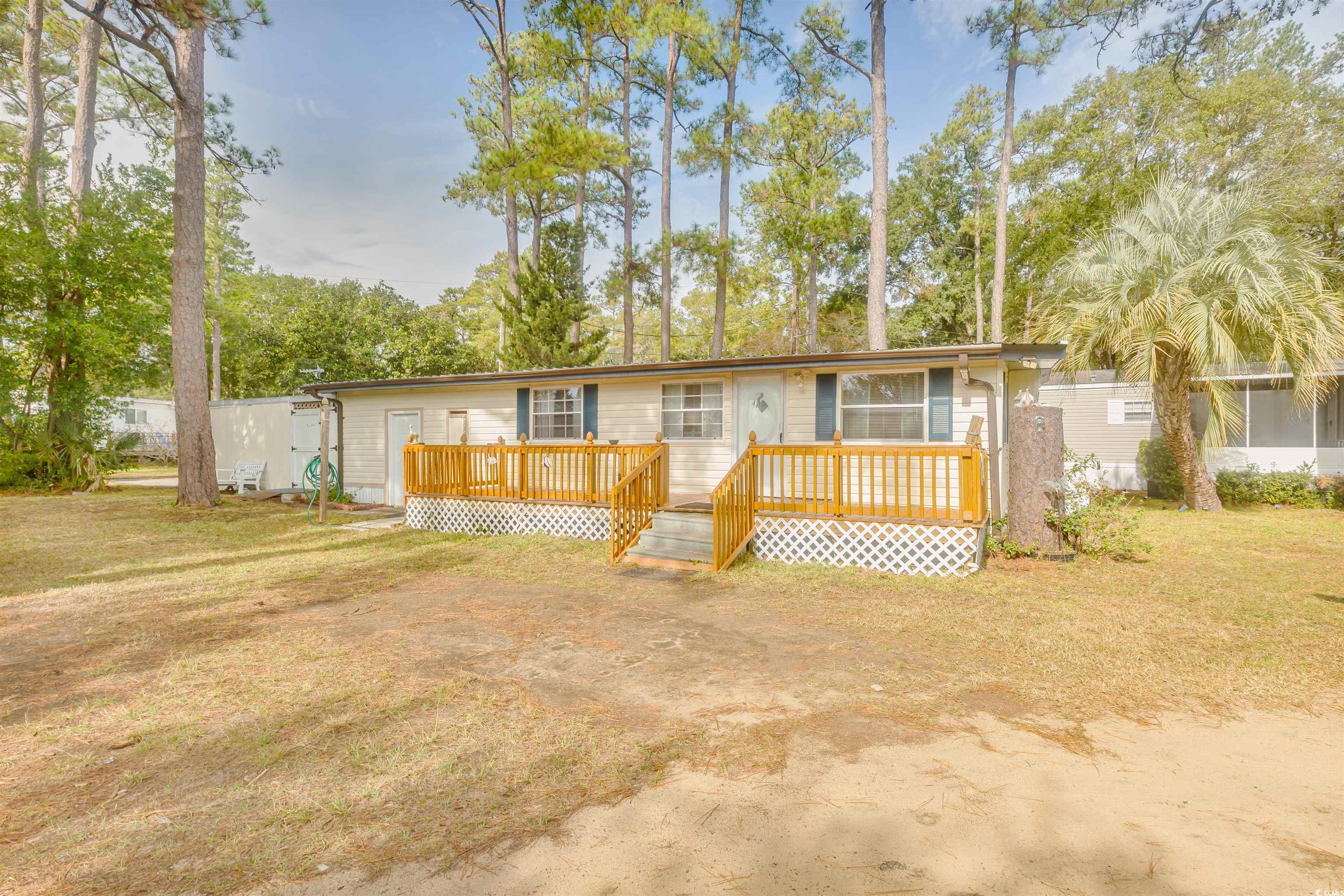 382 West Canal Street Murrells Inlet, SC 29576 - Photo 2 of 38 Single story home with a wooden deck and a front lawn