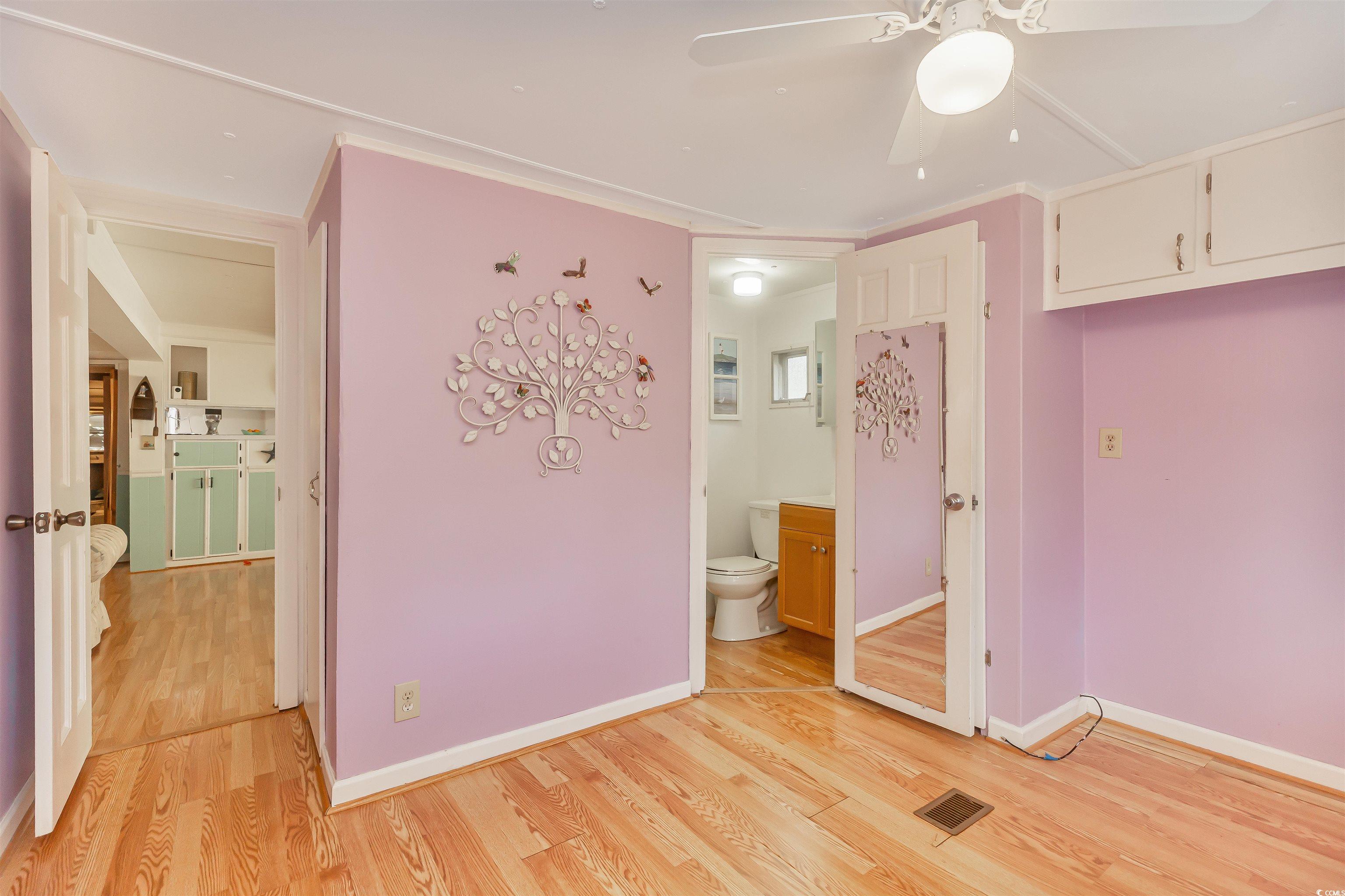 382 West Canal Street Murrells Inlet, SC 29576 - Photo 23 of 38 Unfurnished bedroom with ensuite bath, ornamental molding, and light hardwood / wood-style flooring