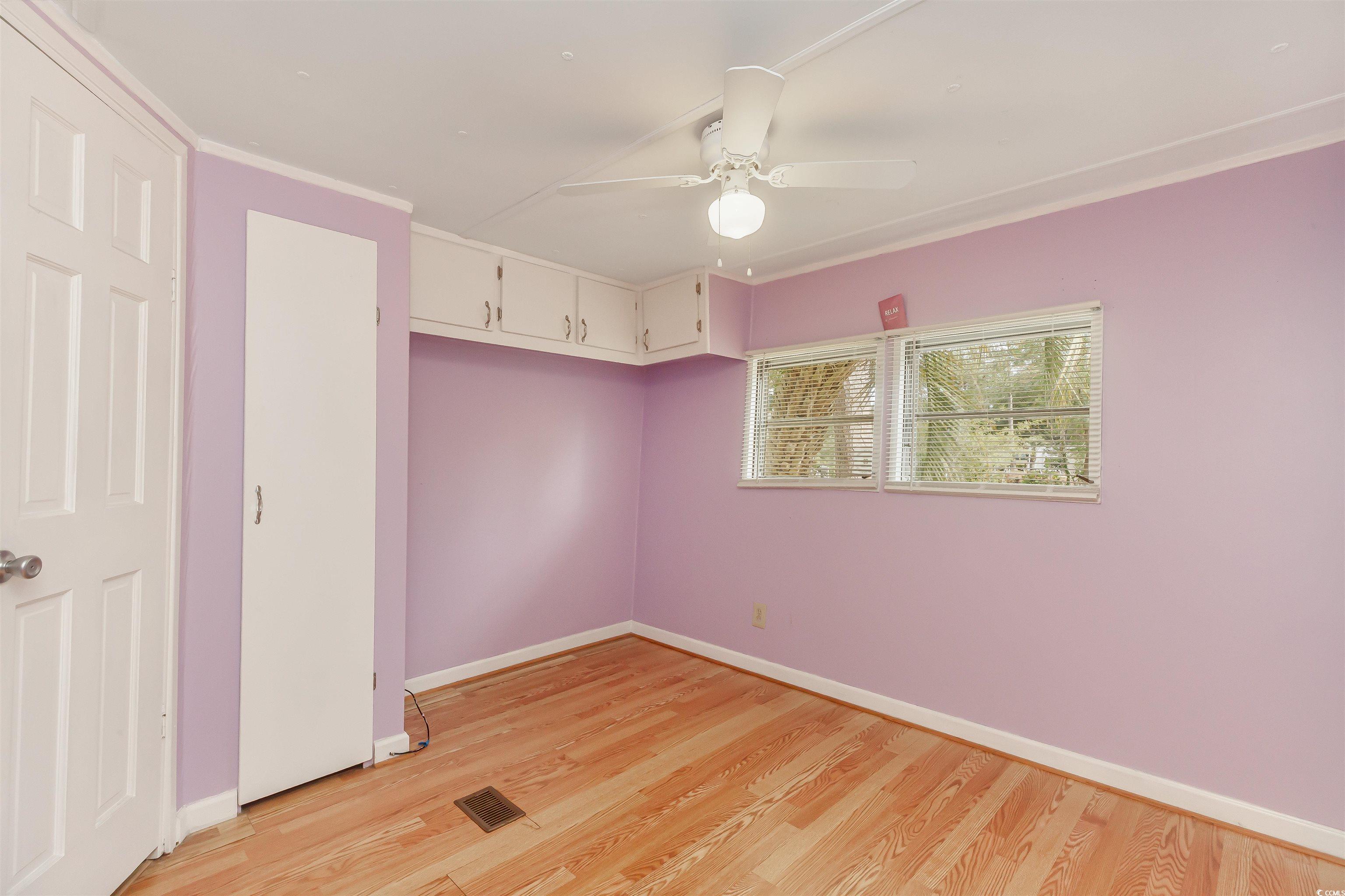382 West Canal Street Murrells Inlet, SC 29576 - Photo 24 of 38 Unfurnished bedroom featuring crown molding, ceiling fan, and light hardwood / wood-style floors