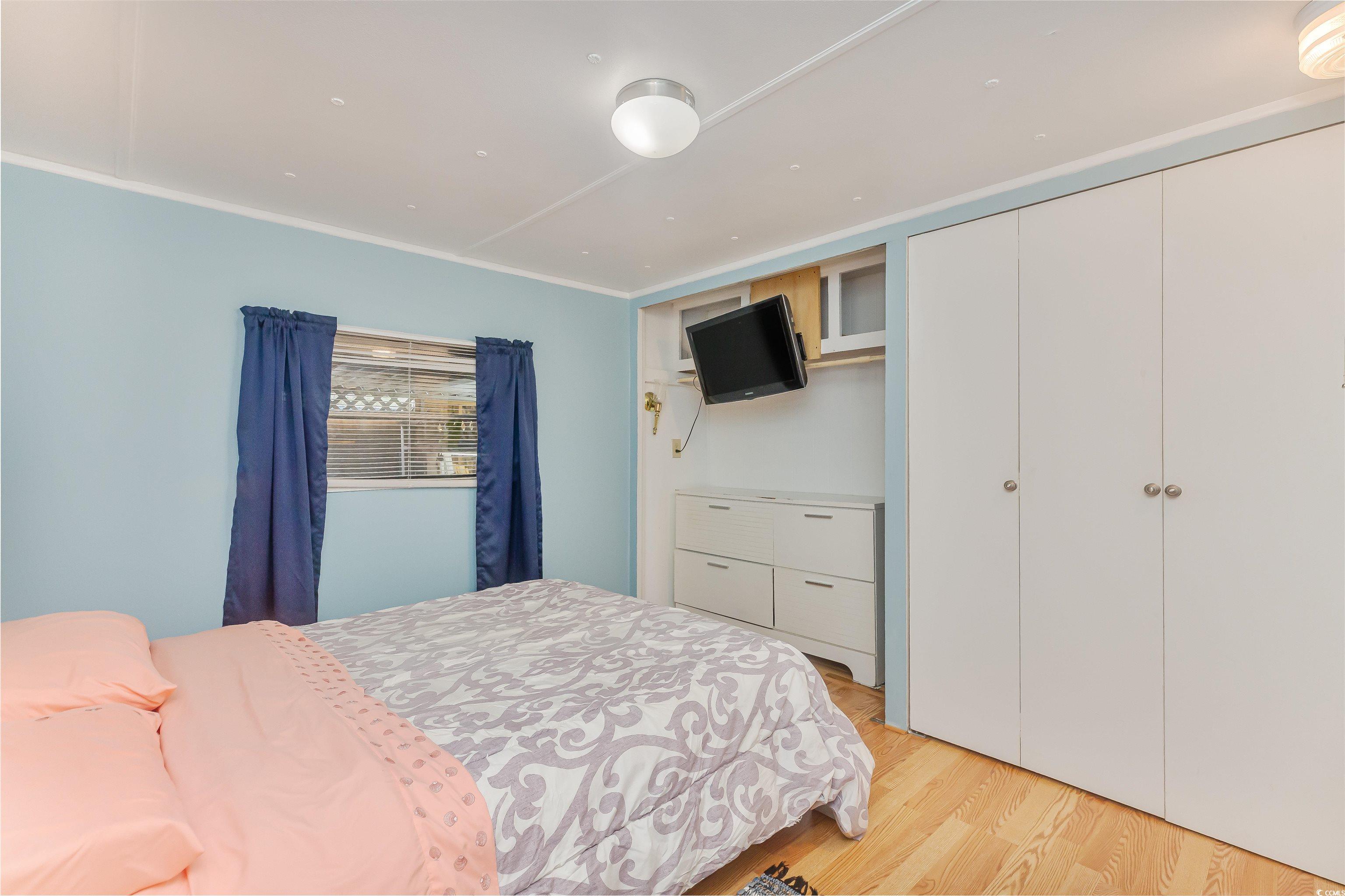382 West Canal Street Murrells Inlet, SC 29576 - Photo 26 of 38 Bedroom with crown molding, light hardwood / wood-style floors, and a closet