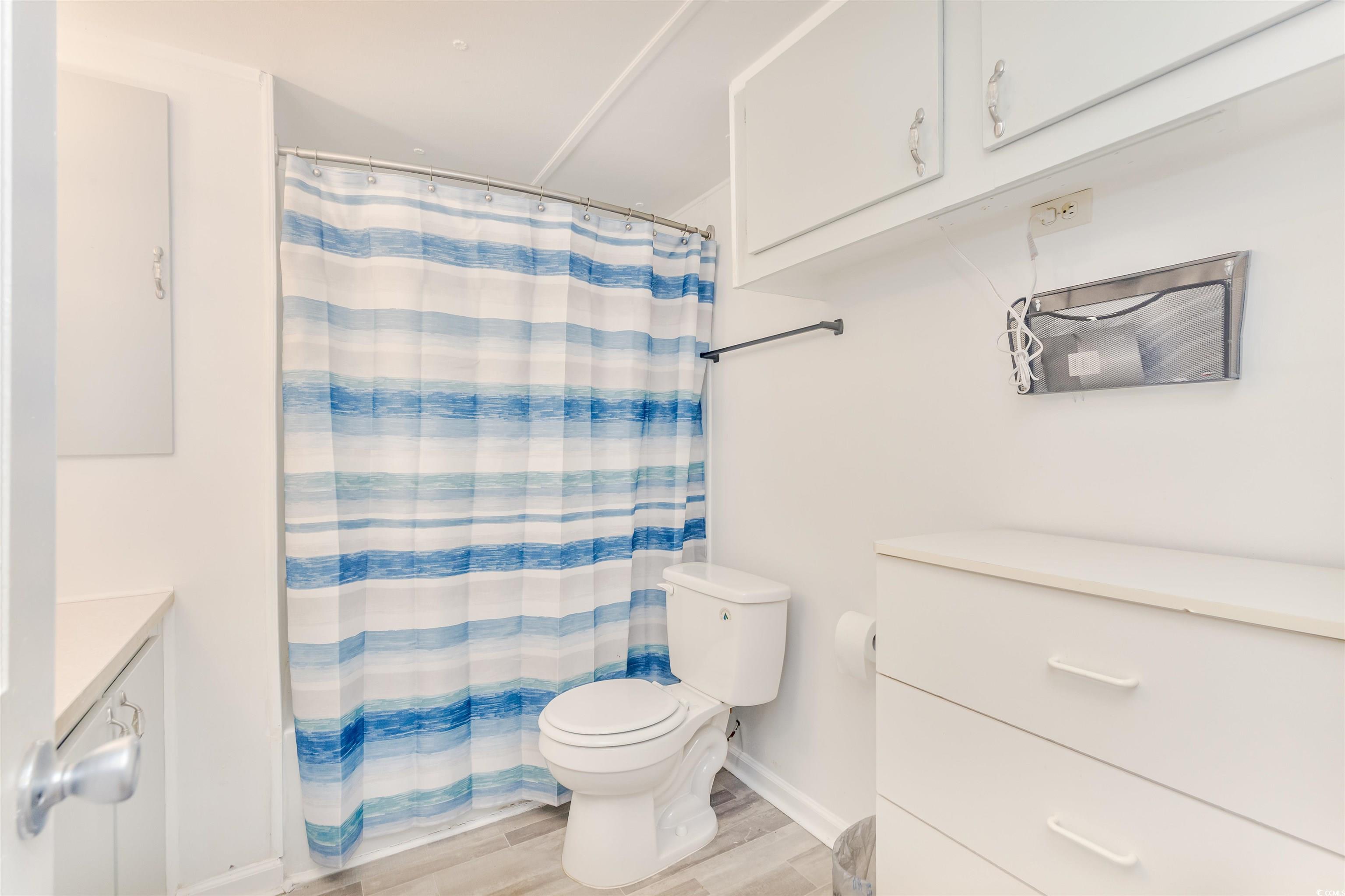 382 West Canal Street Murrells Inlet, SC 29576 - Photo 28 of 38 Bathroom with vanity, toilet, curtained shower, and wood-type flooring