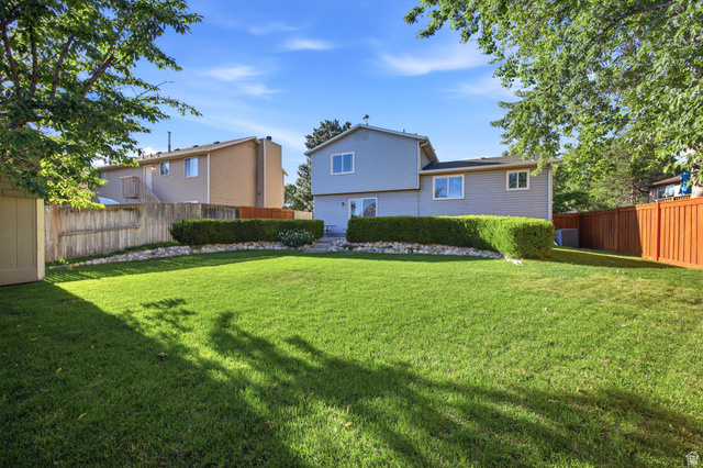 734 Sandy Dunes Drive Sandy, UT 84094 - Photo 28 of 36 Expansive manicured lawn with mature perimeter trees including a mature cherry tree