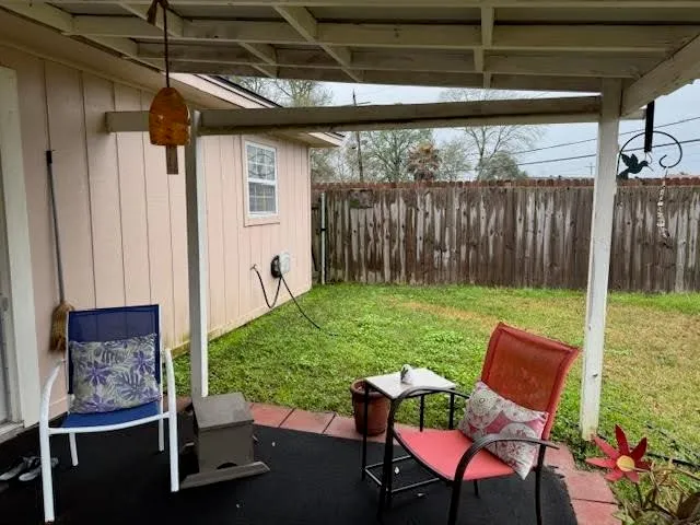 a backyard of a house with table and chairs