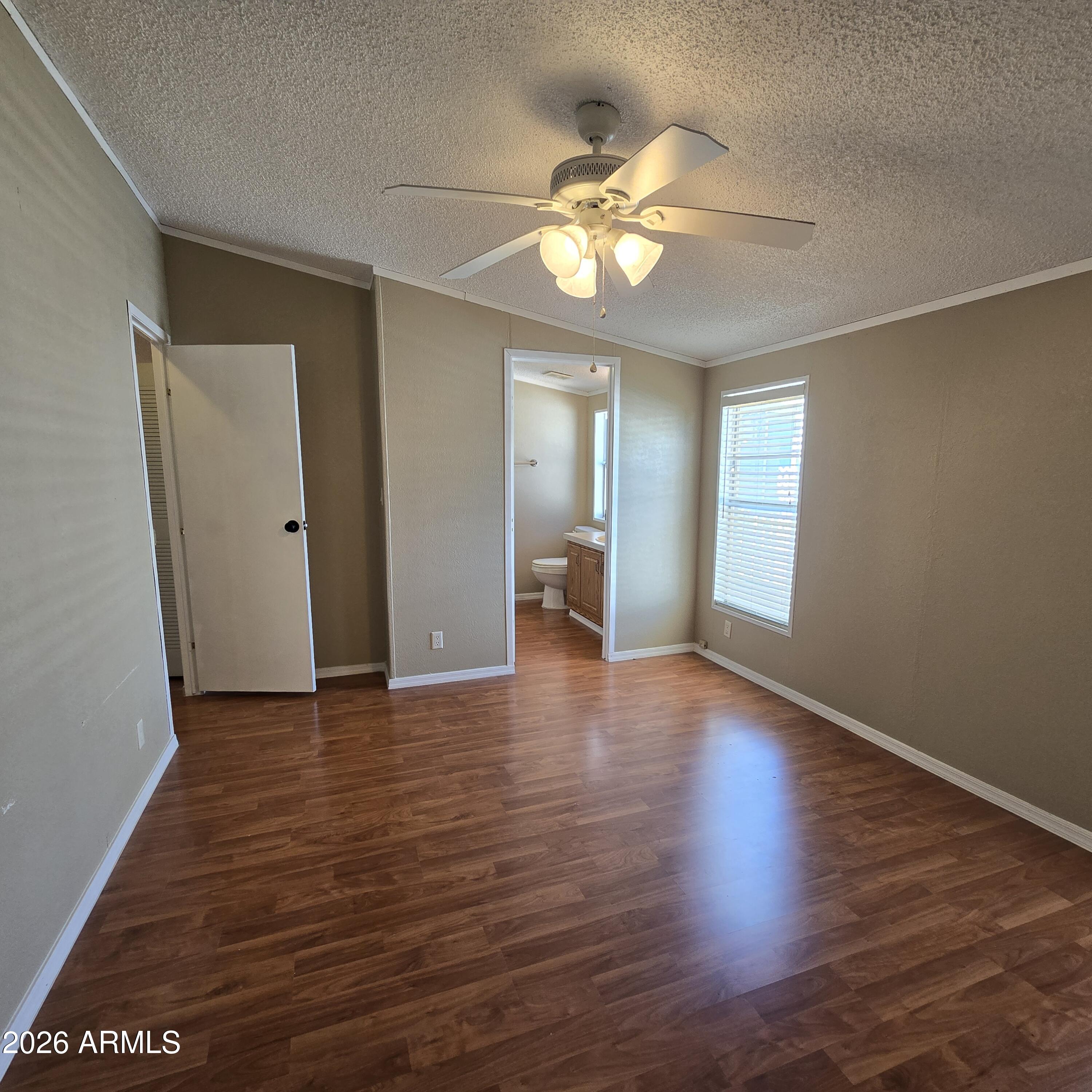 205 West Bell Road, Unit 131 Phoenix, AZ 85023 - Photo 13 of 47 a view of an empty room with wooden floor and fan
