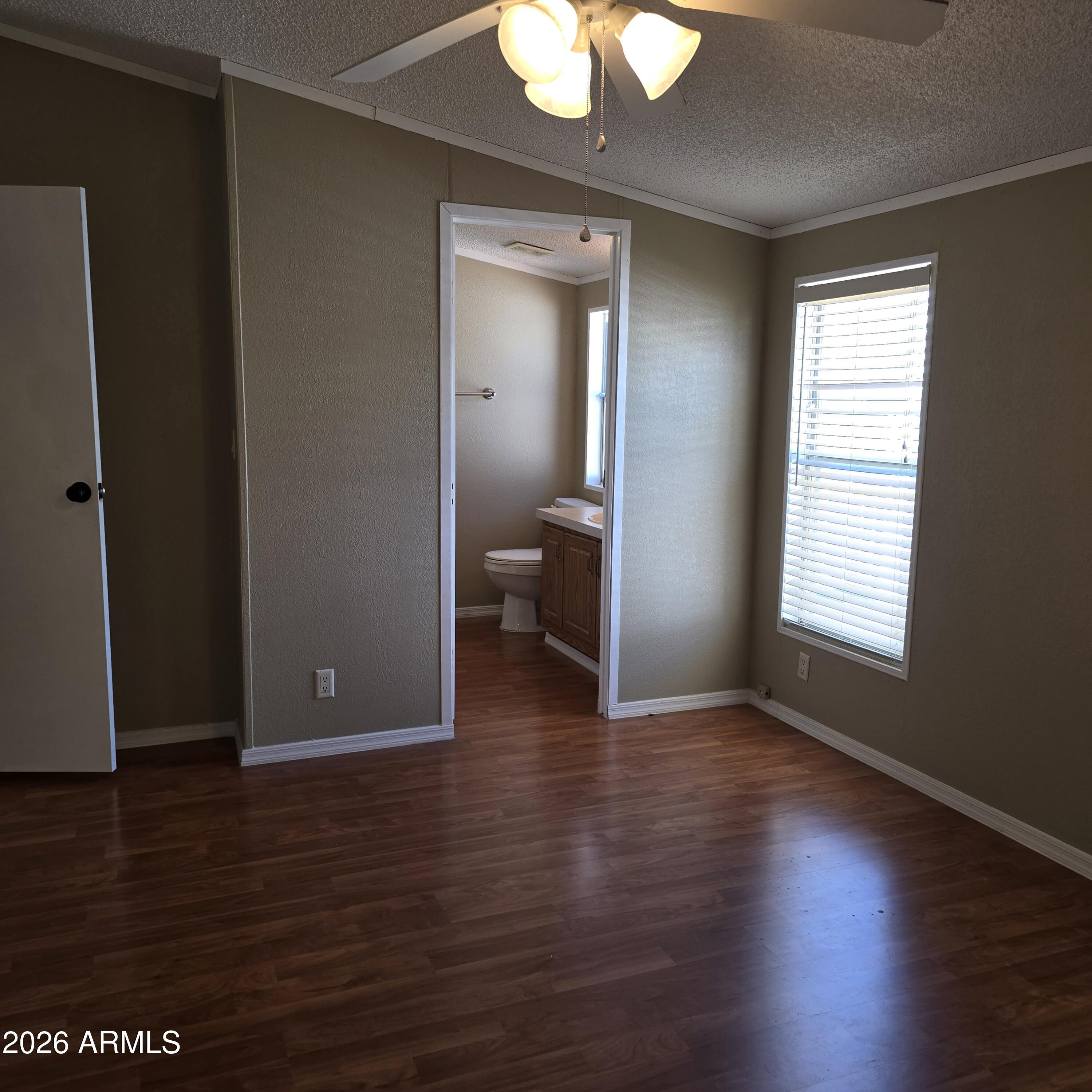 205 West Bell Road, Unit 131 Phoenix, AZ 85023 - Photo 14 of 47 a view of an empty room with wooden floor and a window