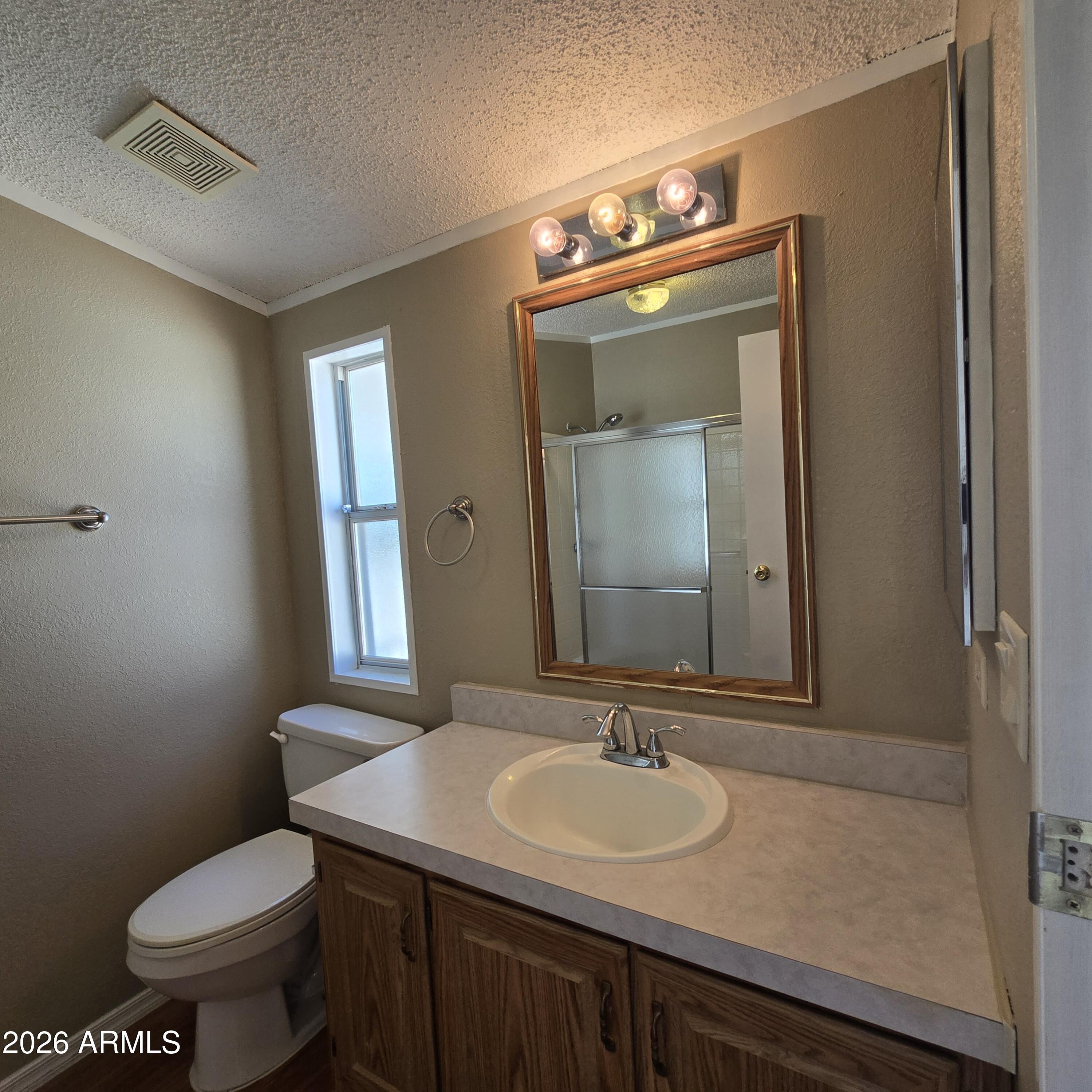205 West Bell Road, Unit 131 Phoenix, AZ 85023 - Photo 15 of 47 a bathroom with a toilet sink and mirror