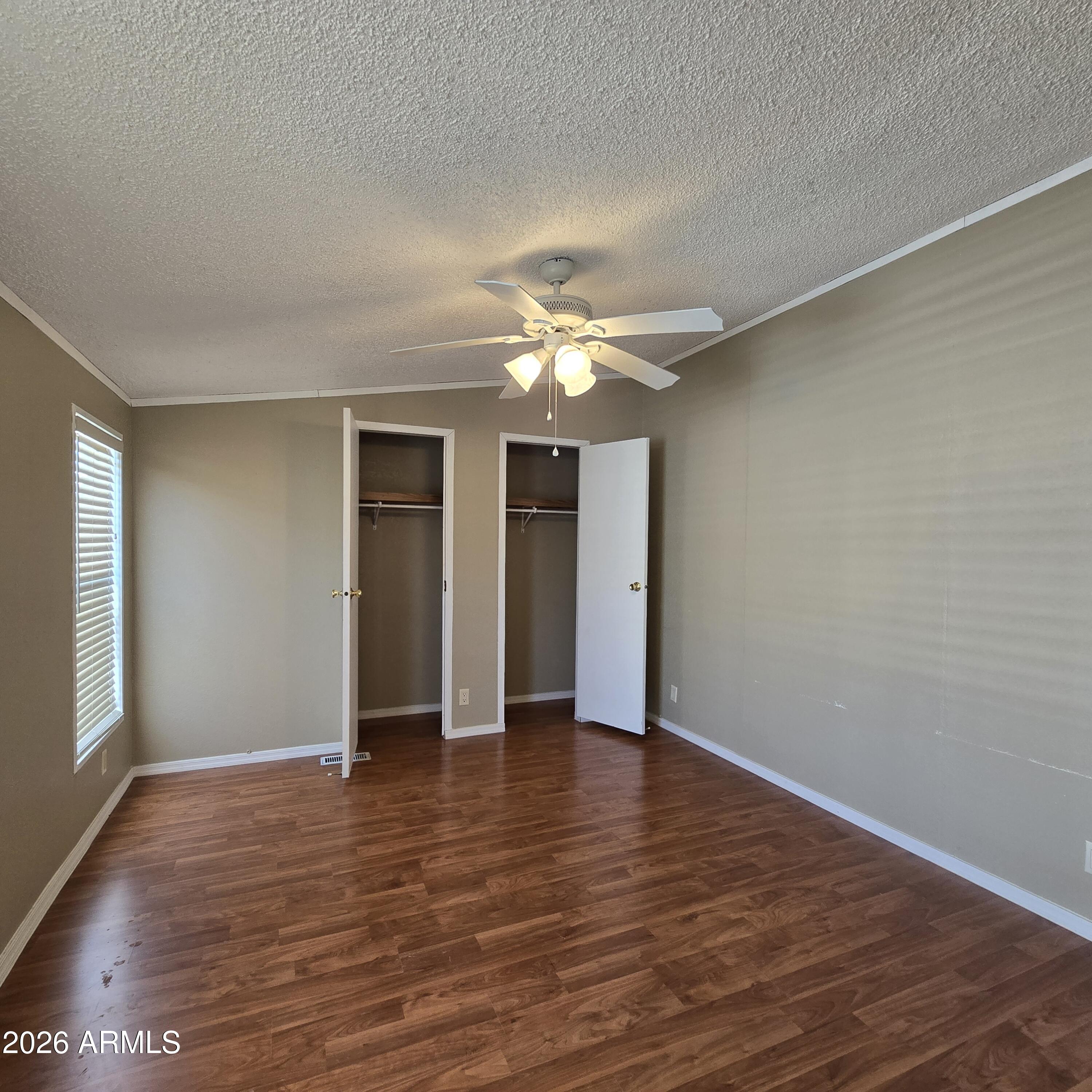 205 West Bell Road, Unit 131 Phoenix, AZ 85023 - Photo 17 of 47 a view of an empty room with wooden floor and a window