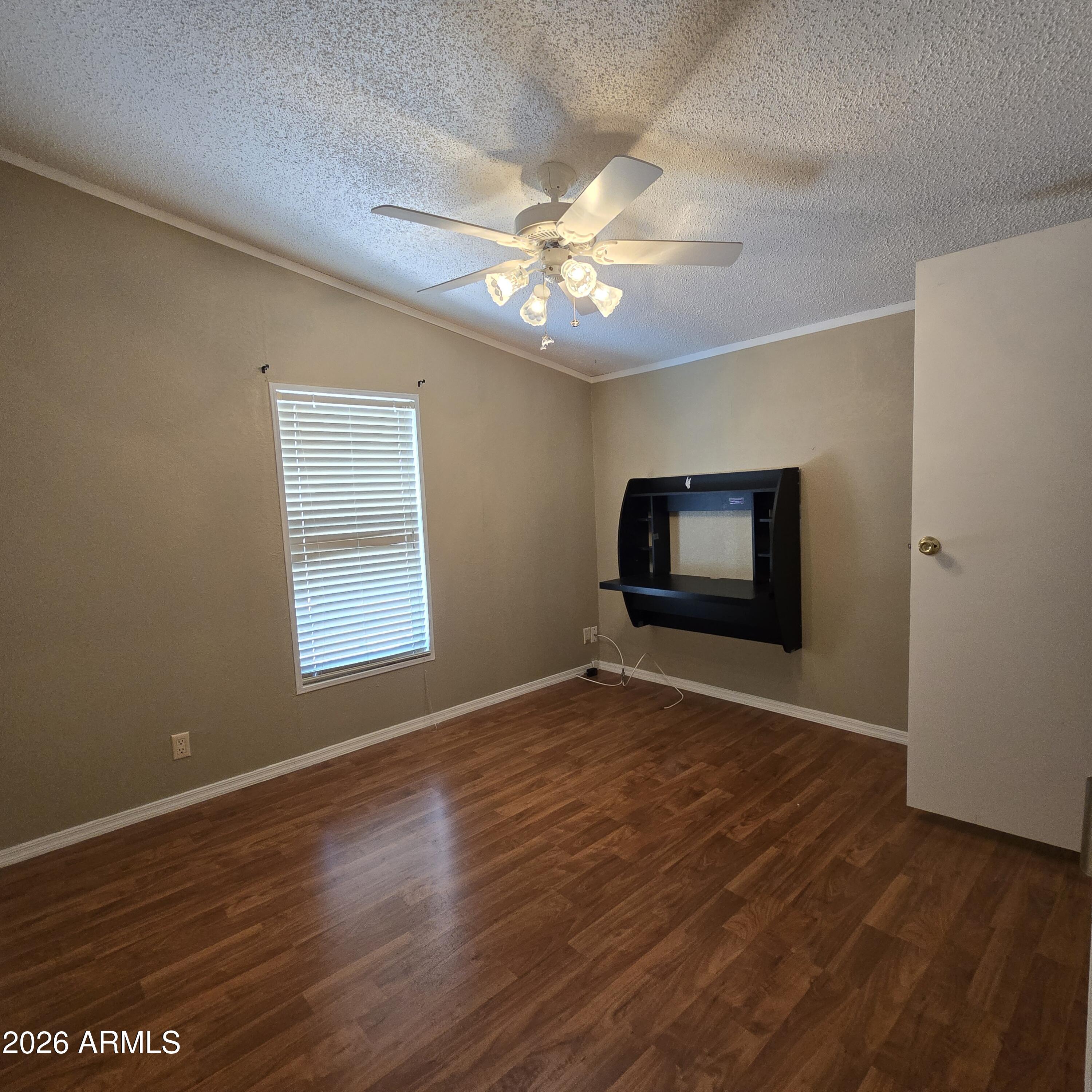 205 West Bell Road, Unit 131 Phoenix, AZ 85023 - Photo 19 of 47 an empty room with wooden floor fan and windows