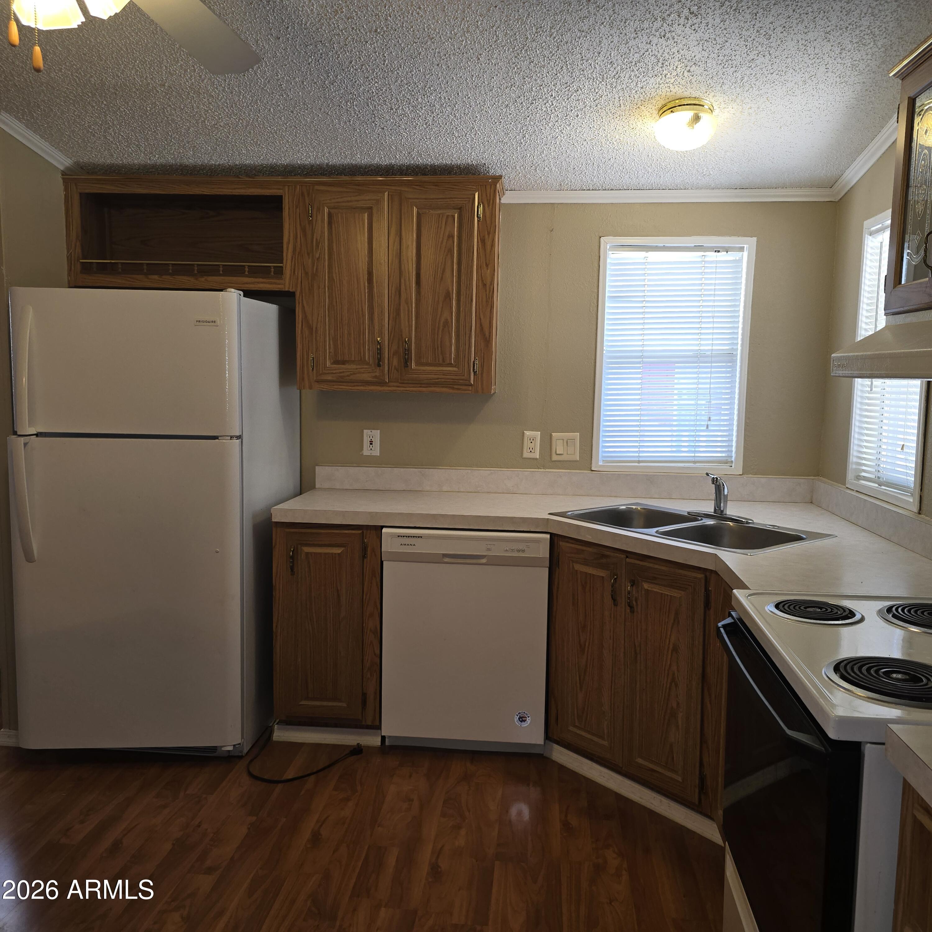 205 West Bell Road, Unit 131 Phoenix, AZ 85023 - Photo 24 of 47 a kitchen with a sink a refrigerator and window
