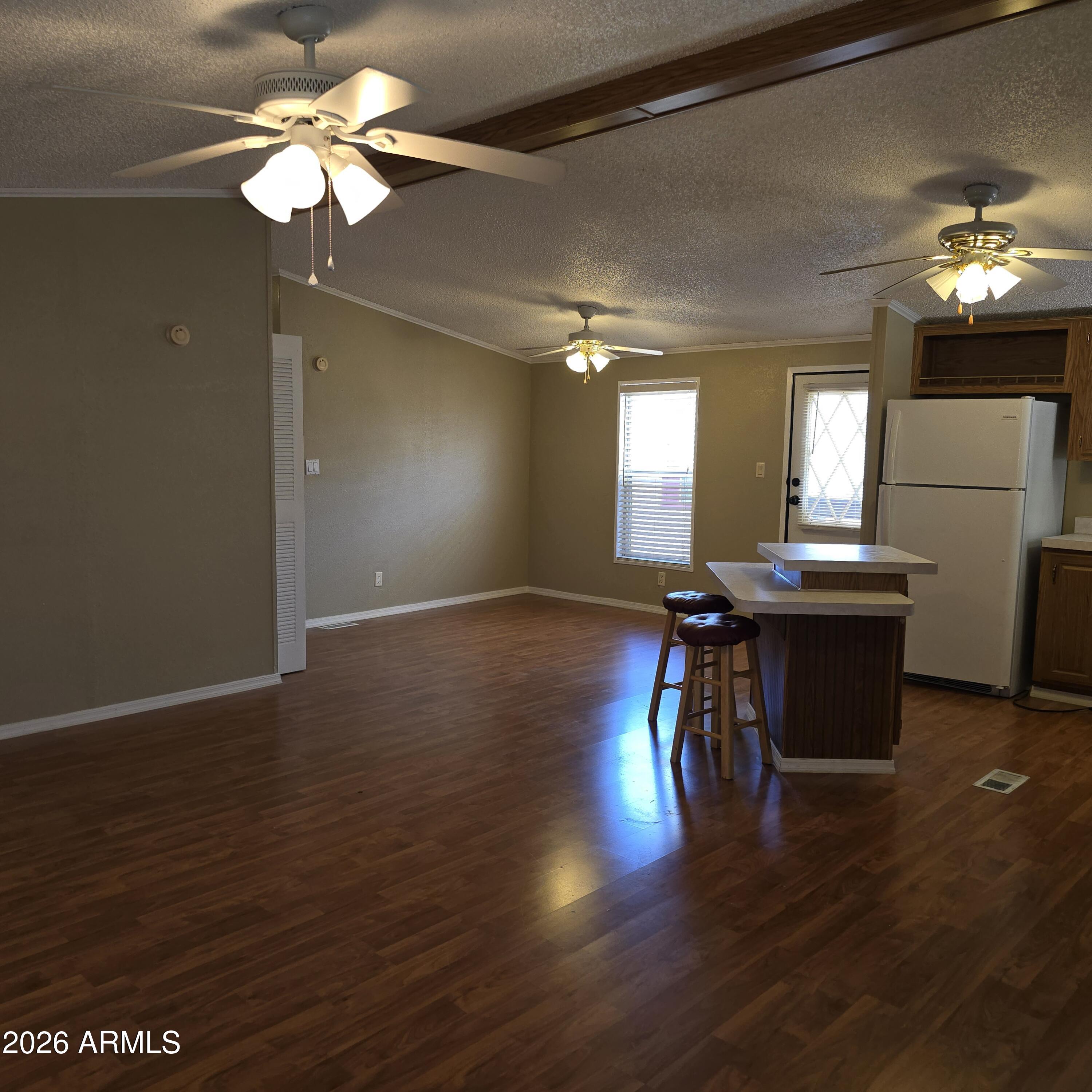 205 West Bell Road, Unit 131 Phoenix, AZ 85023 - Photo 4 of 47 a view of a room with chandelier fan and wooden floor