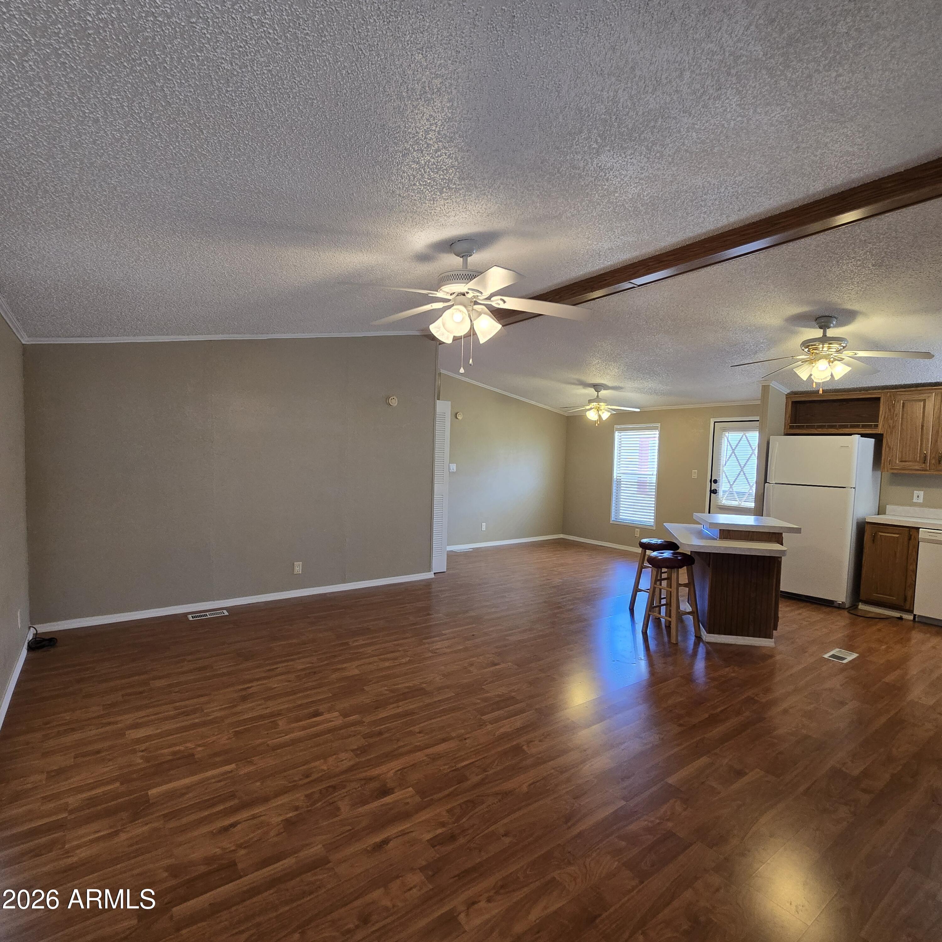 205 West Bell Road, Unit 131 Phoenix, AZ 85023 - Photo 6 of 47 a view of a room with wooden floor and a ceiling fan