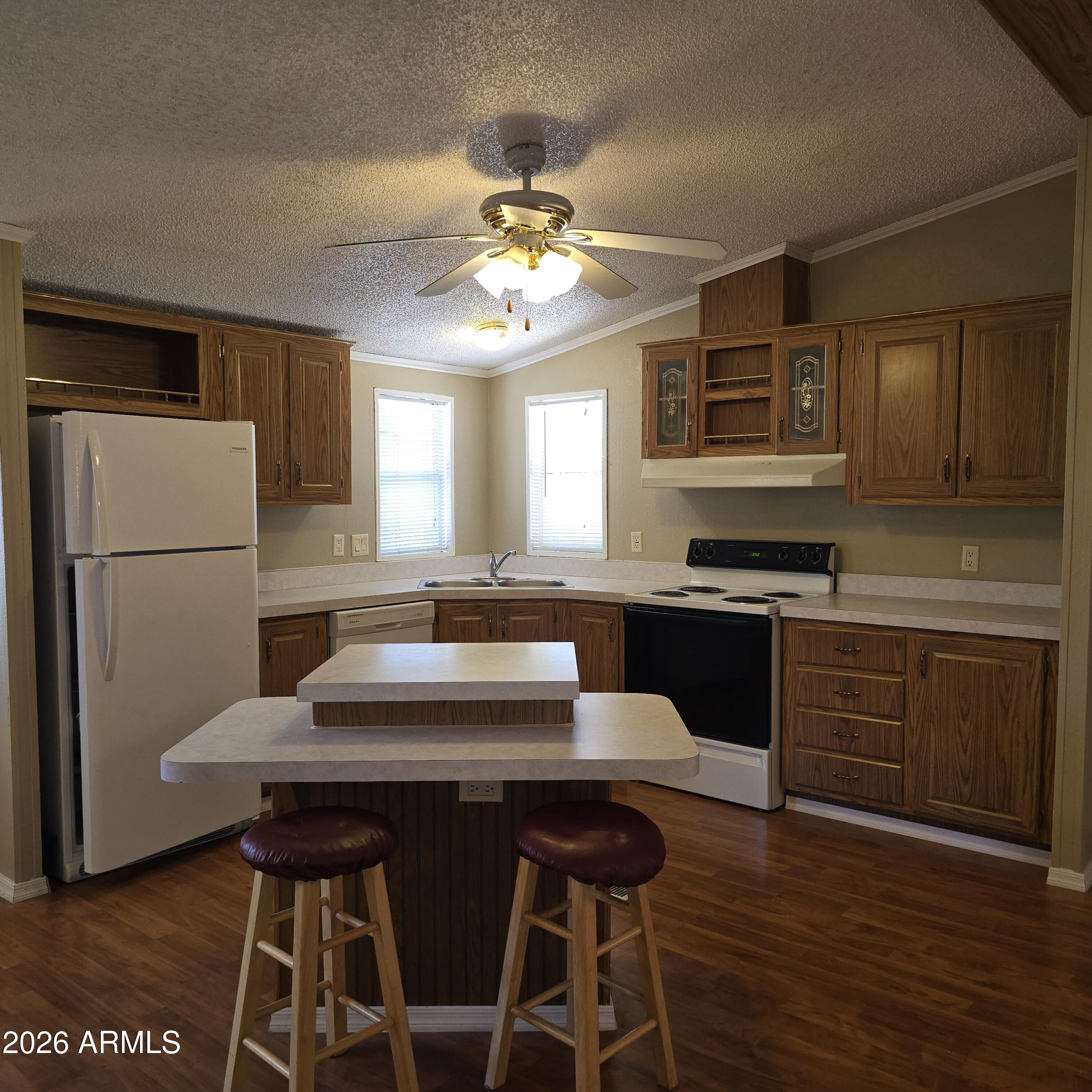 205 West Bell Road, Unit 131 Phoenix, AZ 85023 - Photo 8 of 47 a kitchen with a refrigerator and a stove top oven