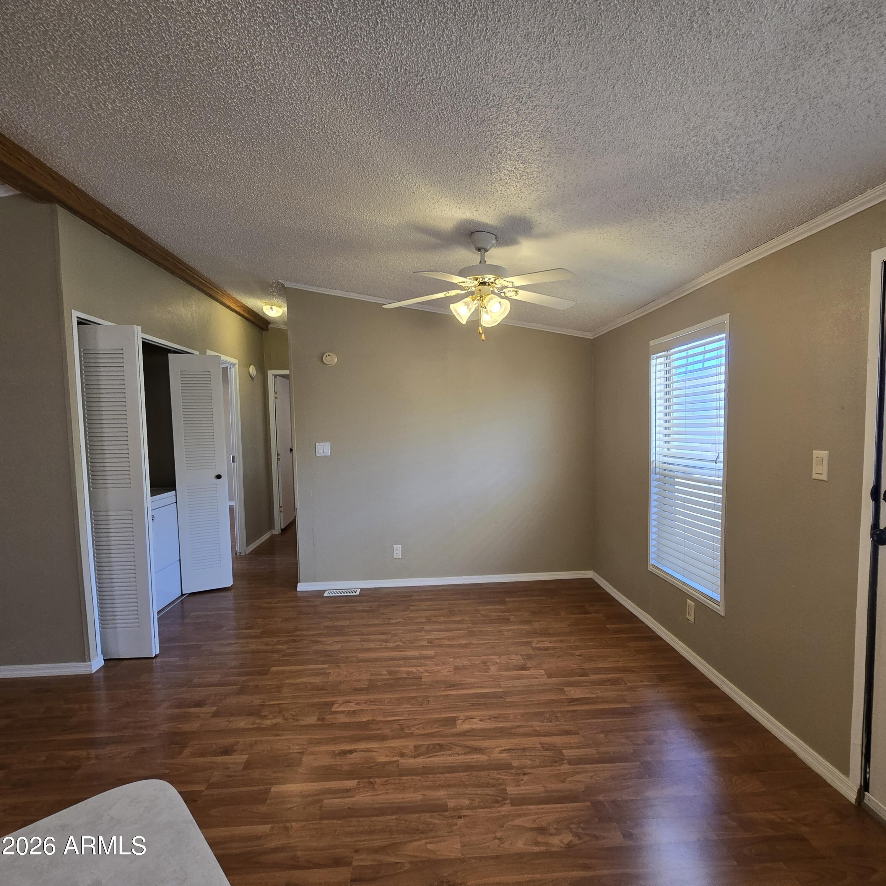 205 West Bell Road, Unit 131 Phoenix, AZ 85023 - Photo 9 of 47 a view of an empty room with wooden floor and a window