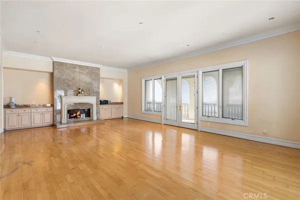 a living room with fireplace furniture and a large window