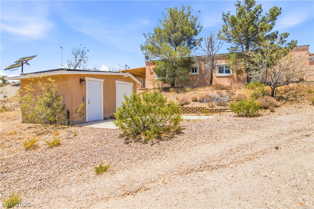 Rocking S Ranch Road Searchlight, NV 89046 - Photo 43 of 47 Perched on a sun-drenched hill, this desert retreat offers a charming stucco facade and detached storage.
