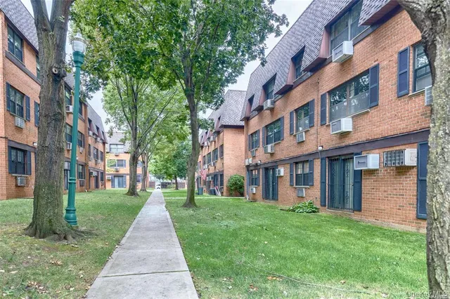a view of a brick building next to a big yard