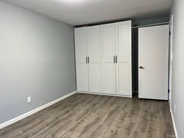 a view of a room with wooden floor and brick wall