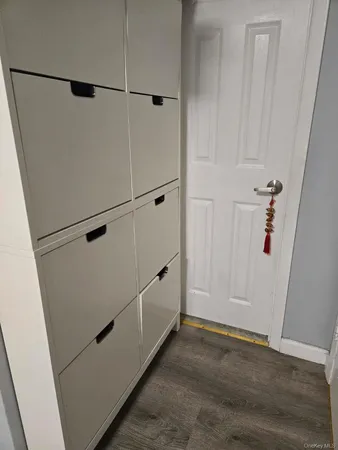 a view of a closet with wooden floor