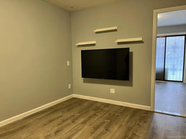 a view of a room with wooden floor and brick wall
