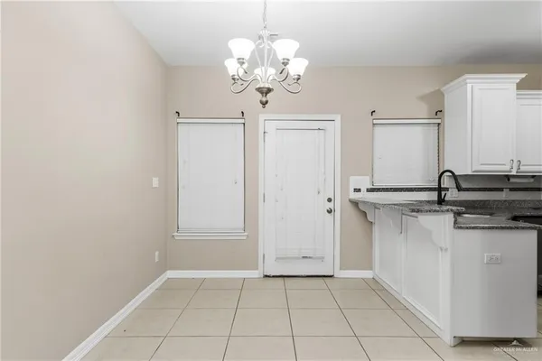 a bathroom with a granite countertop sink a mirror and a vanity