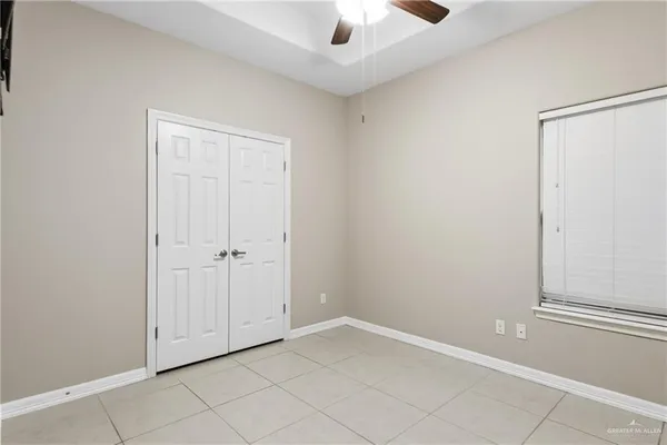 a bathroom with a granite countertop sink mirror vanity and toilet