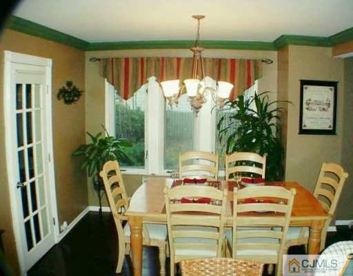 222 Old Post Road Edison, NJ 08817 - Photo 3 of 8 a dining room with furniture potted plants and wooden floor