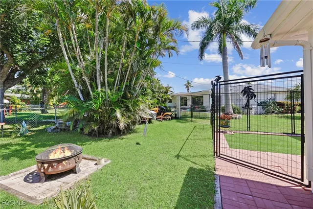 a view of backyard with outdoor seating and green space