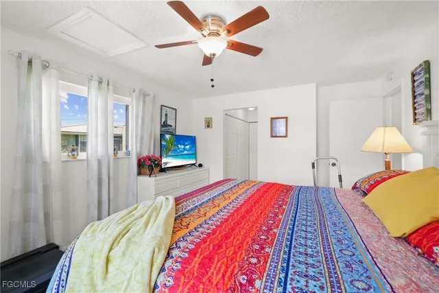 a bedroom with a bed and a lamp