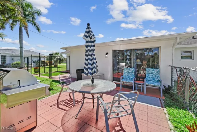 a view of a patio with a table and chairs