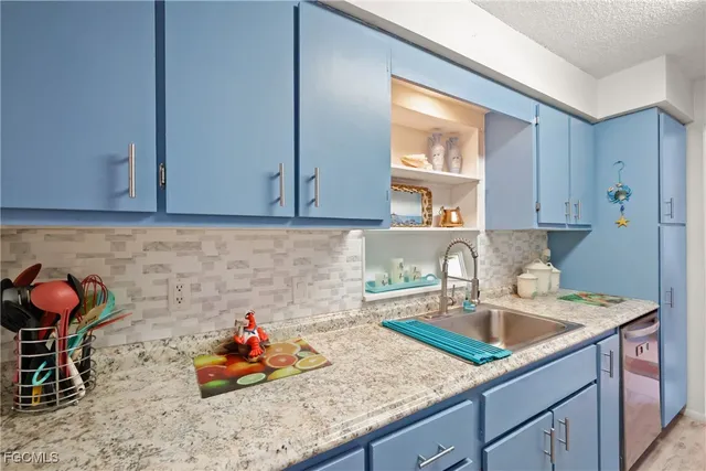 a kitchen with sink cabinets and utility