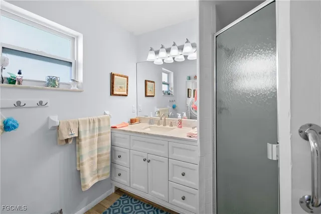 a bathroom with a sink vanity granite and a mirror